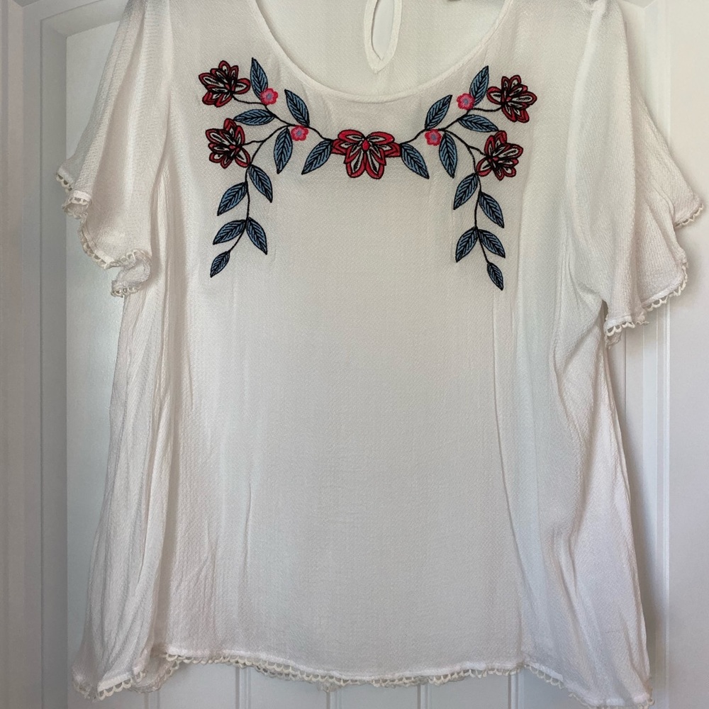 A white (is see threw) top with flowers